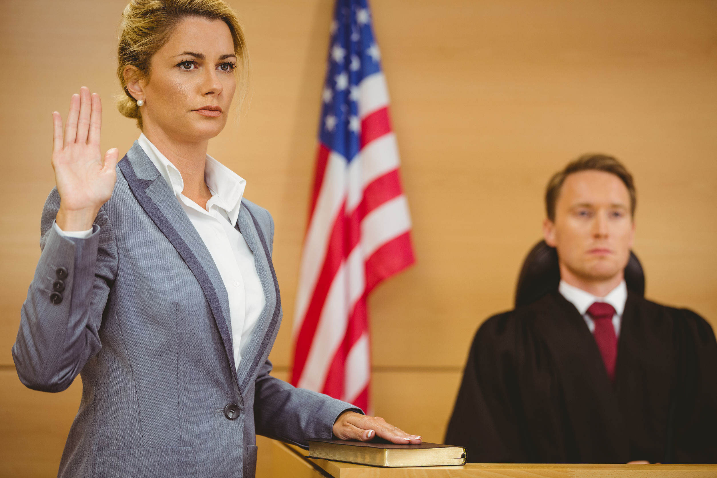 Witness swearing on the bible telling the truth in the court room